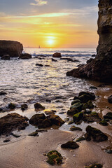 Sunrise at the rocky coastline of Praia dos Estudantes Beach, Lagos, Algarve, Portugal	