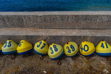 Obraz premium Winning the lottery colorful buoys with numbers and letters on the seashore
