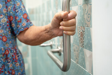 Asian elderly woman use bathroom handle security in toilet, healthy strong medical.