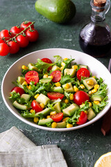Salad with avocado, tomatoes and corn. Healthy eating. Vegetarian food.