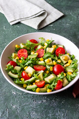 Salad with avocado, tomatoes and corn. Healthy eating. Vegetarian food.
