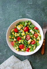 Salad with avocado, tomatoes and corn. Healthy eating. Vegetarian food.