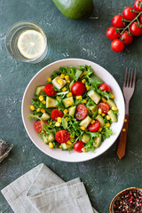 Salad with avocado, tomatoes and corn. Healthy eating. Vegetarian food.