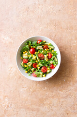 Salad with avocado, tomatoes and corn. Healthy eating. Vegetarian food.