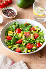 Salad with avocado, tomatoes and corn. Healthy eating. Vegetarian food.