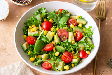 Salad with avocado, tomatoes and corn. Healthy eating. Vegetarian food.