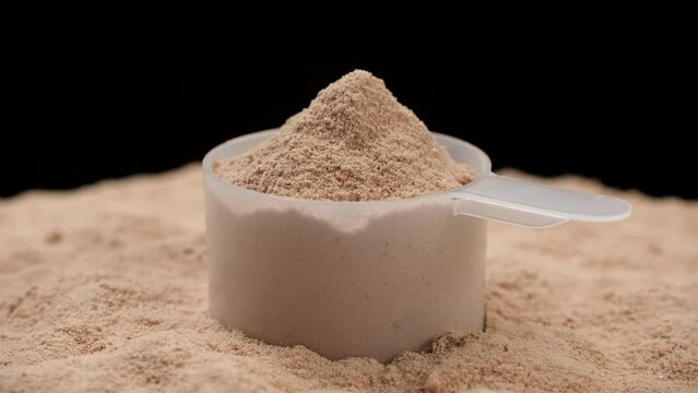 Chocolate color protein, whey powder in cup. Bodybuilding, fitness and gym lifestyle