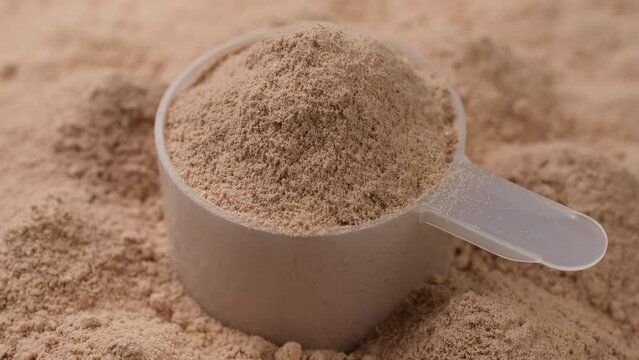 Chocolate color protein, whey powder in cup. Bodybuilding, fitness and gym lifestyle