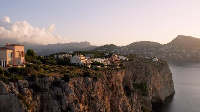 Amazing villas and luxury holiday homes on edge of cliff in prestigious gated community in Mallorca. Residential expensive housing and apartments blocks built in epic landscape of mediterranean