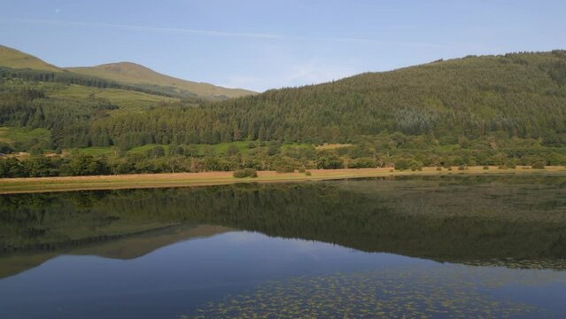 Aerial view of Loch Lubnaig surrounded by majestic mountains and serene forest, Highlands, United Kingdom.