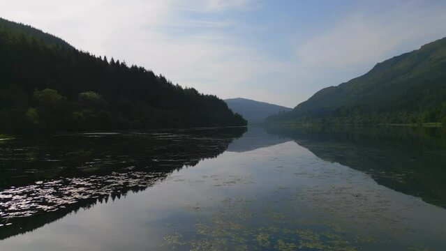Aerial view of Loch Lubnaig surrounded by majestic mountains and lush forest, Highlands, United Kingdom.