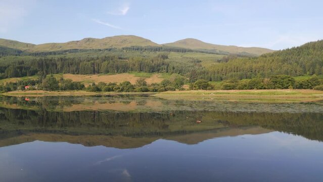 Aerial view of Loch Lubnaig surrounded by mountains and forest, Highlands, United Kingdom.