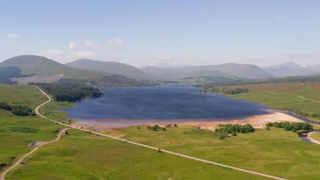 Aerial view of Loch Tulla surrounded by mountains and lake, Highlands, United Kingdom.
