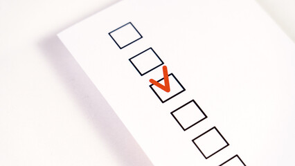 A form with a checkbox for selection and a red checkmark, a concept of choice, Checkbox with red Check mark, red check mark on paper, Agree, check boxes on white sheet. Red check mark.