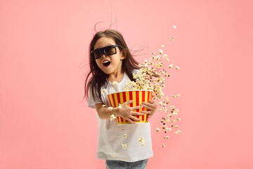 Shocked Surprised Little Kid Girl 5-6 years Old in 3D Glasses Watching Movie Film in Cinema,...