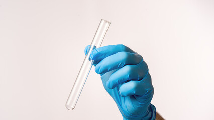 Empty medical test tube in laboratory assistant's hand on white background, concept of medical research and laboratory work. © Антон Скрипачев