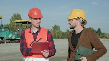 Male communicate with builder, controlling work process