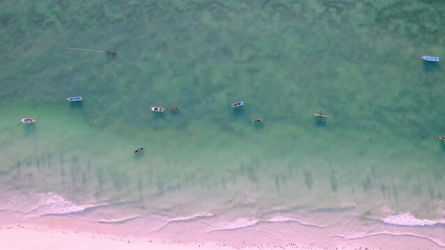 Aerial view of tranquil sea shore and fishing boats along Indian Ocean, Diani, Kwale, Kenya.