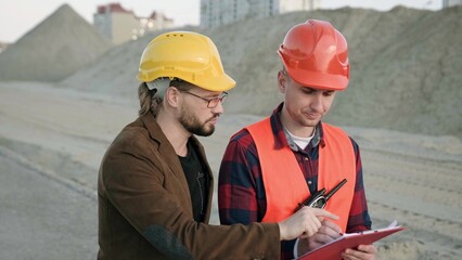 Men discuss about work process on site