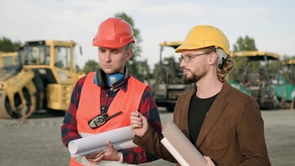 Architect discuss about work process on site with builder