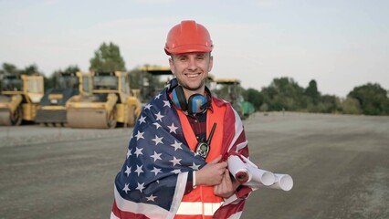 American worker holding blueprints, ready to work on site