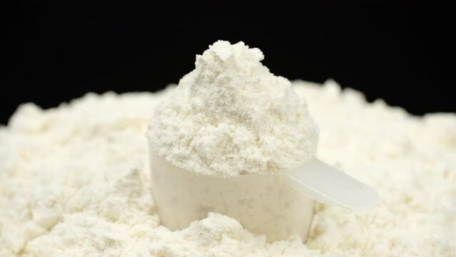 White protein, whey powder in cup. Bodybuilding, fitness and gym lifestyle