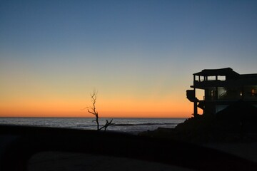 Breathtaking sunset featuring a stunning blue and orange sky over a seashore