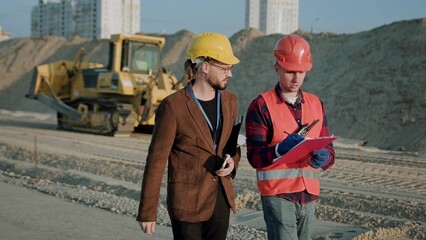 Builder and director at construction site outside