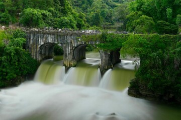 Long exposure shot of an ancient stone bridge in Guizhou province, China.