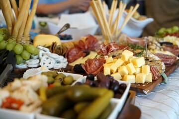 Delicious looking charcuterie board with a variety of gourmet cheeses, meats, and olives