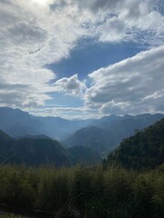 a mountain is shown with blue skies and some green grass