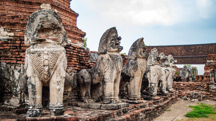 Ancient lion statues located around an old Ayutthaya period pagoda at Wat Thammikarat, Phra Nakhon...