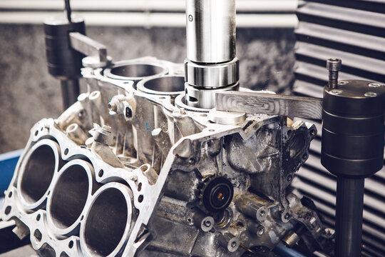 Engine cylinder boring on cnc machine. Boring under the piston after engine sleeve using machine with Computer Numerical Control.