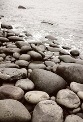 Expansive stretch of rocky beach washed by the lapping waves of the sea