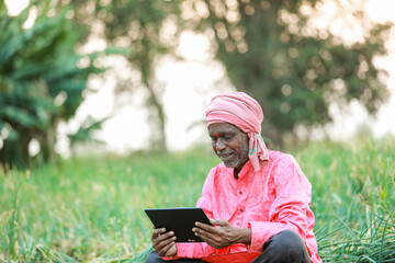 Fototapeta premium Indian farm worker holding tablet