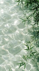 Clear light greenish-white sea with a few greenish bamboo leaves, shimmering water surface reflection, white water color, serene, top view angle