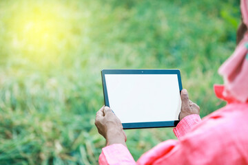Indian farm worker holding tablet