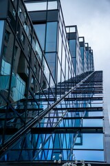 Contemporary tall building features a striking blue glass facade