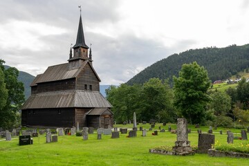 Kaupanger Stave Church in Norway, surrounded by lush, green grass