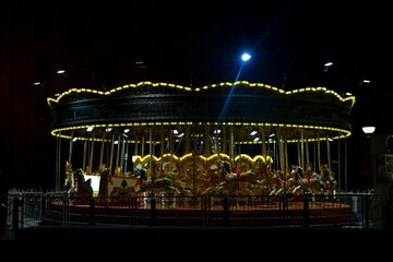 carousel with several lights on top of it at night time