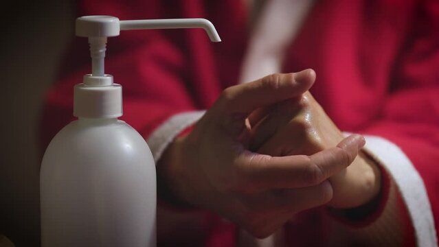 Woman Santa in Costume in Bed with Flue - Facial Mask and Disinfection - Quarantine Concept