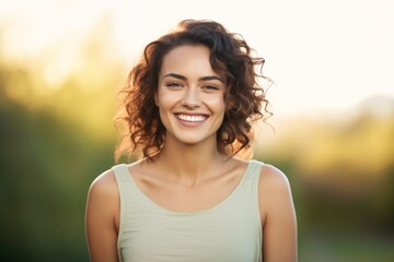 Portrait of a grinning woman in her 20s smiling at the camera isolated in solid pastel color wall