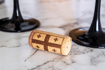 Wine cork with Georgian flag on marble counter