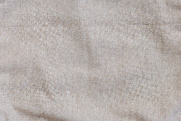 texture of linen natural fabric close-up. Gray fabric with a simple weave.