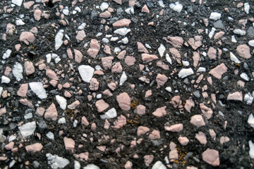 Close-Up of Asphalt Texture with Colorful Gravel Stones for Background Design and Construction...