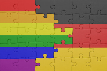 Fototapeta premium puzzle with the colourful national flag of germany and rainbow gay pride flag .