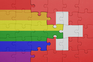 puzzle with the colourful national flag of switzerland and rainbow gay pride flag .