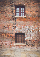 Old red brick building with two windows