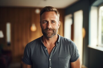 Obraz premium Portrait of a blissful man in his 40s smiling at the camera isolated on scandinavian-style interior background