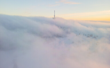 Televison tower in the clouds in Hessen, germany
